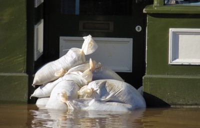 Shop doorway barricaded with sandbags in Tower Street, York, North Yorkshire.
